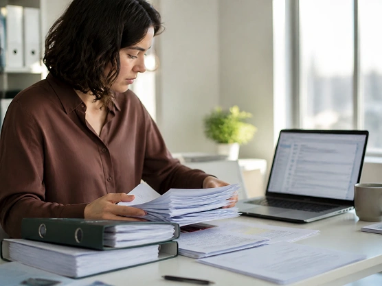 A person organizing source documents that train the assistant