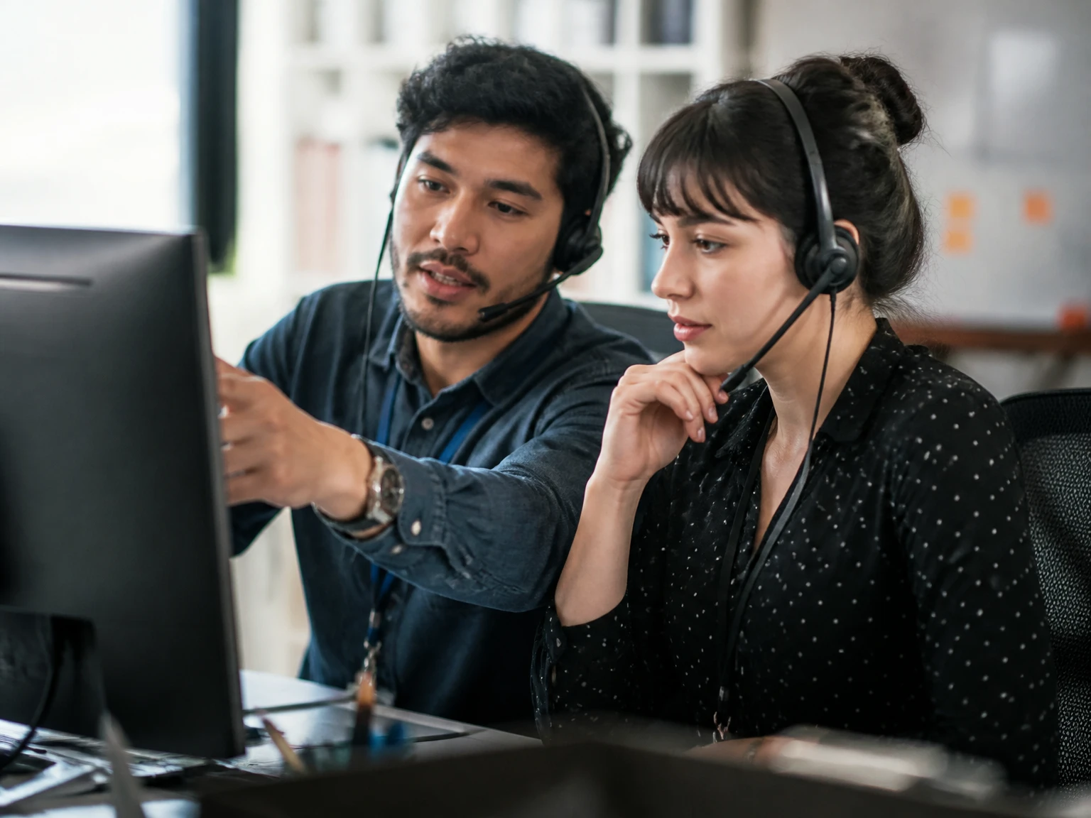 Two support agents collaborating on an escalated ticket