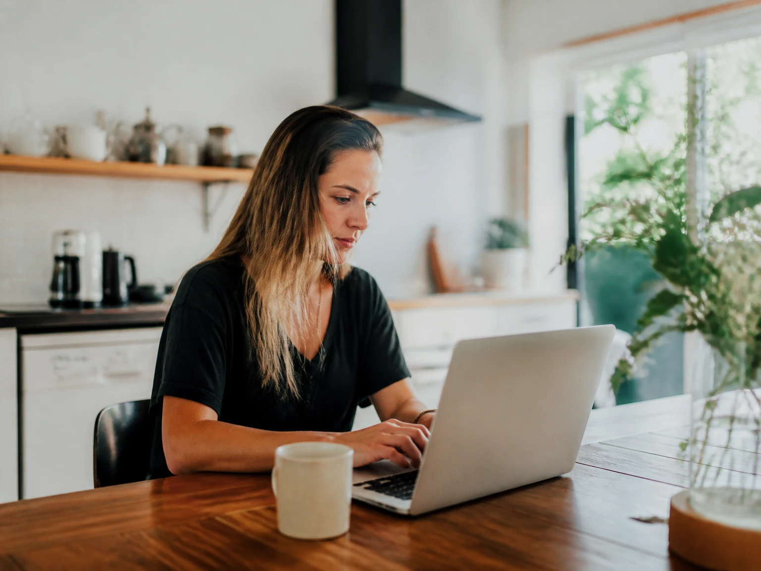 A freelancer working comfortably from a laptop at home